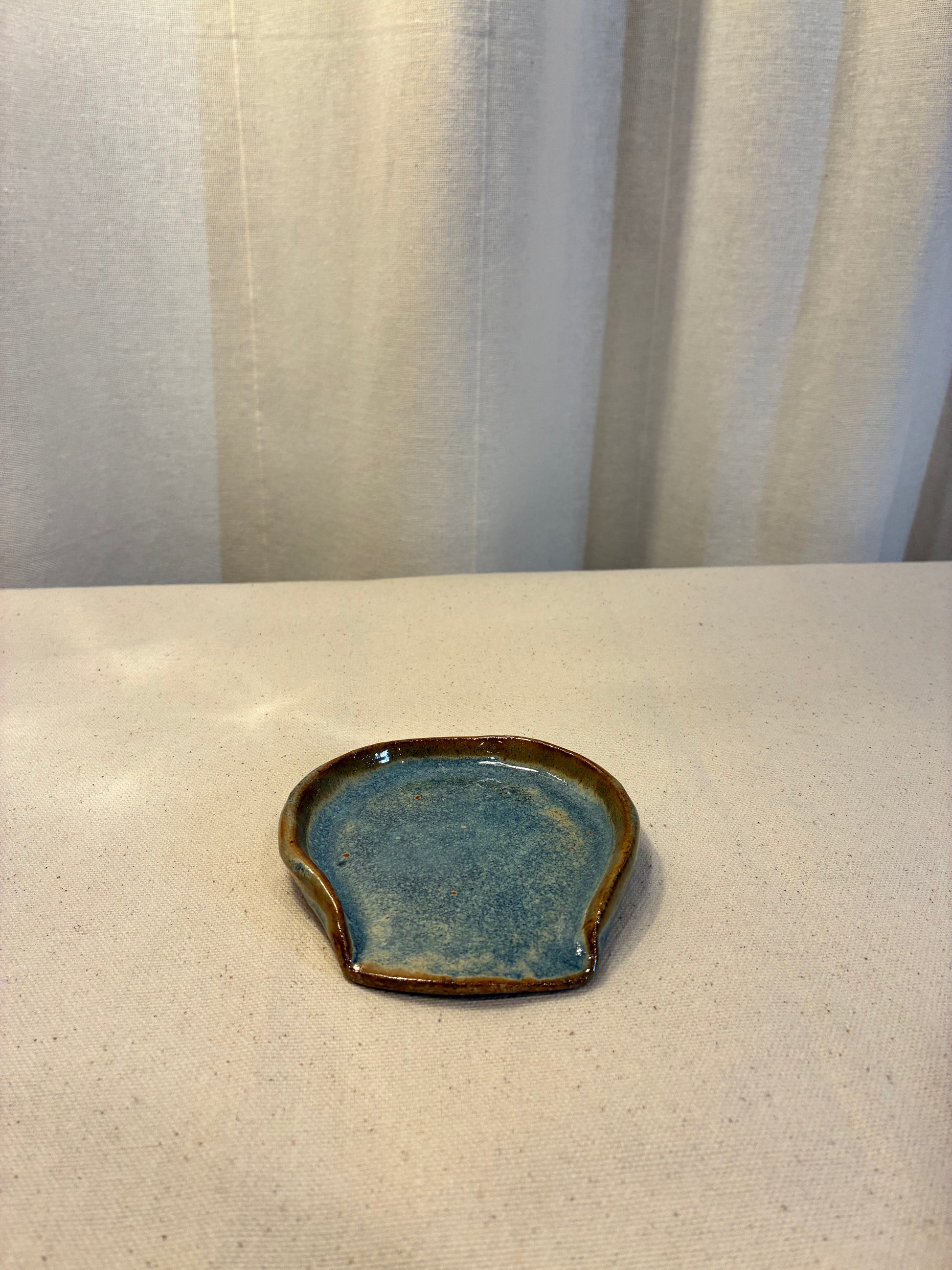 Small handmade, ceramic blue and brown spoon rest